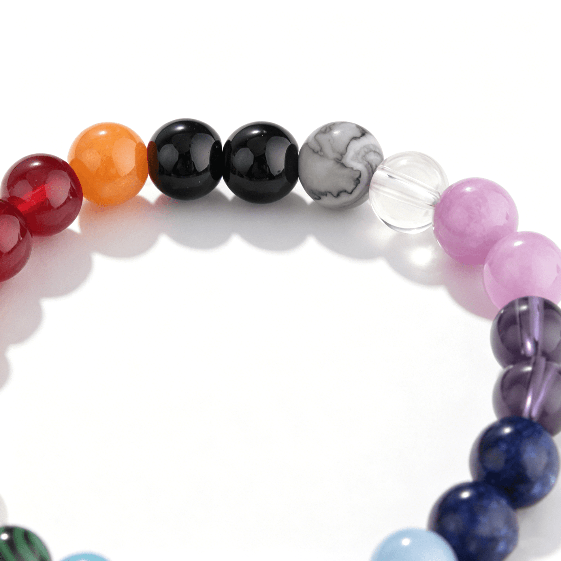 Close-up of Ever P. 6.5mm rainbow strawberry quartz beads, highlighting the diverse natural inclusions in this beaded bracelet.
