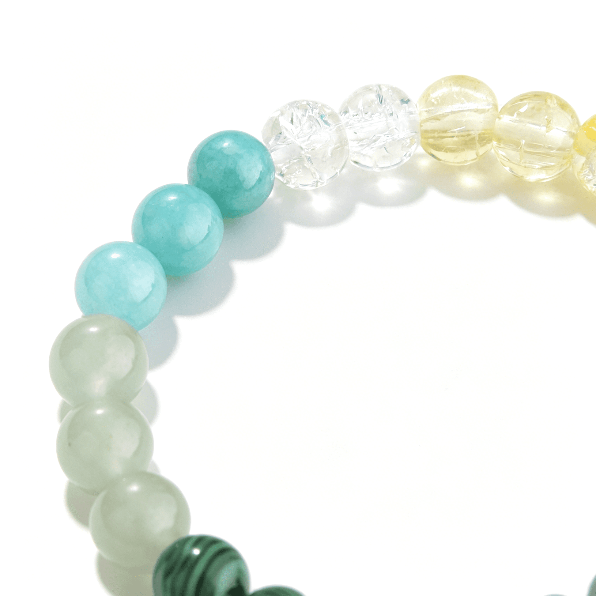 Detail view of the adjustable 19.5cm gold-tone extension chain on the Ever P. green strawberry quartz healing crystal bracelet.