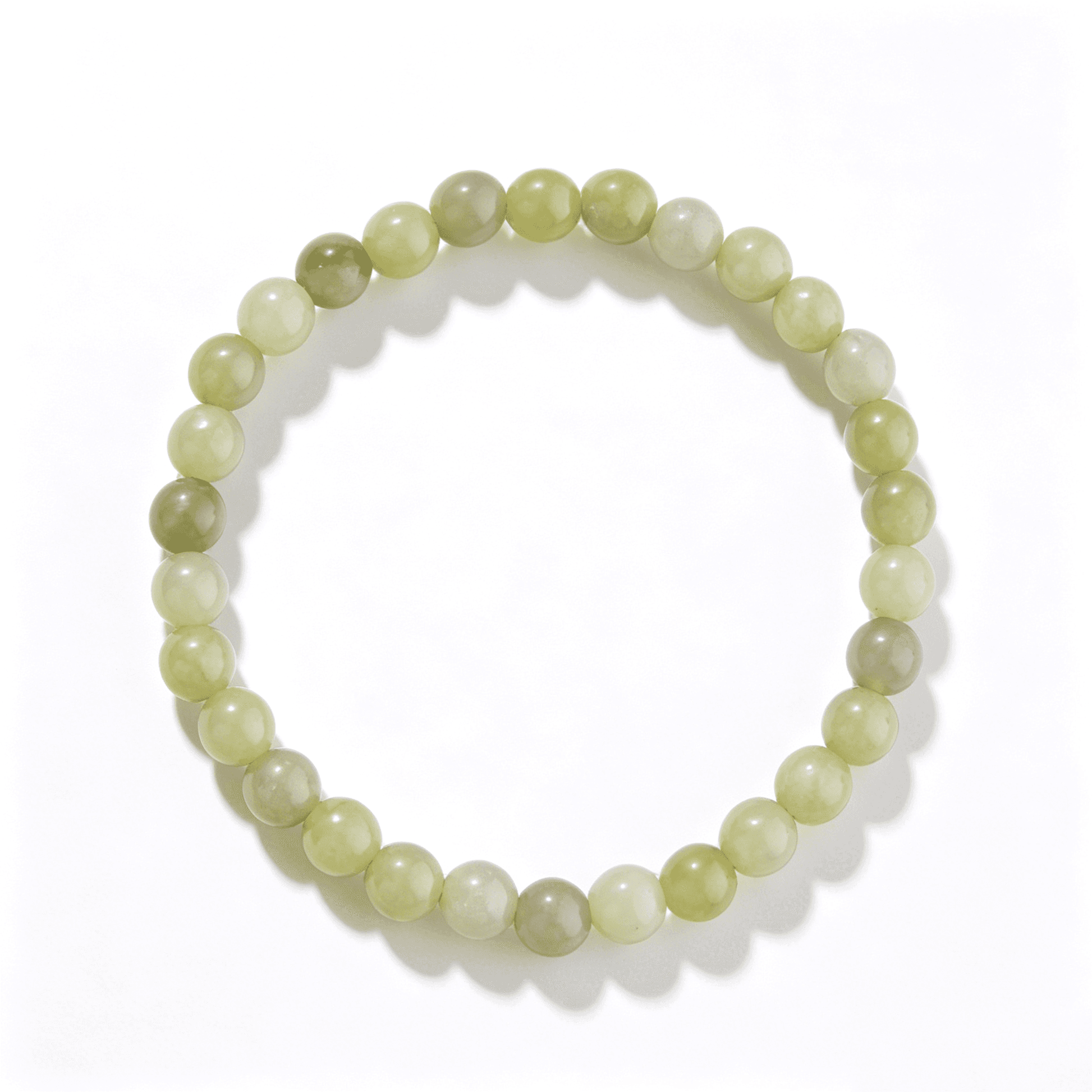 The circular alignment of the adjustable Lime Dew agate bracelet against a bright background.