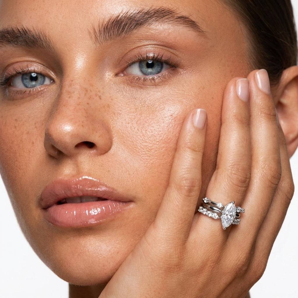 Close-up of an adjustable stackable ring set from Ever P., highlighting the sparkling marquise and round cubic zirconia stones on a model's finger.