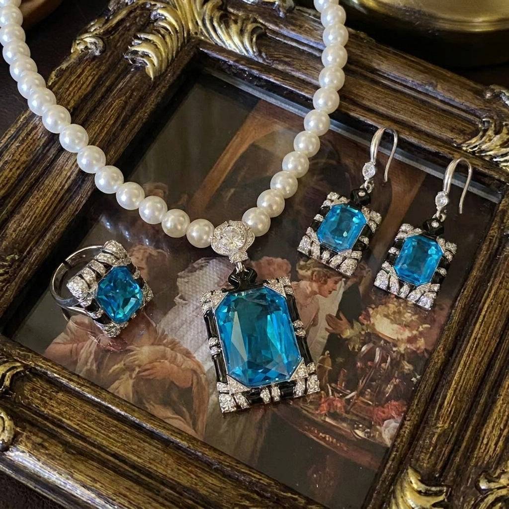 Ever P. vintage aquamarine jewelry set including pearl necklace, drop earrings, and adjustable ring.