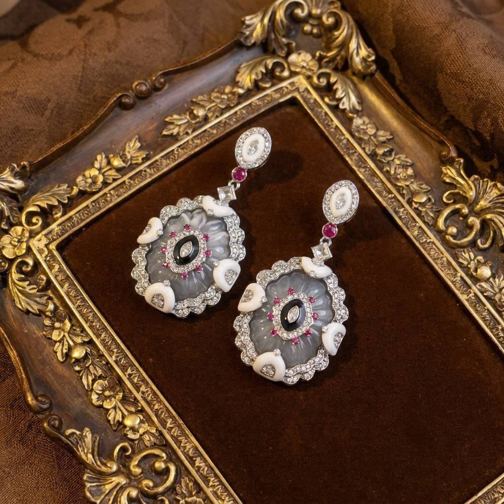 Statement Victorian style dangles featuring a rich antique gold finish and vibrant accents.