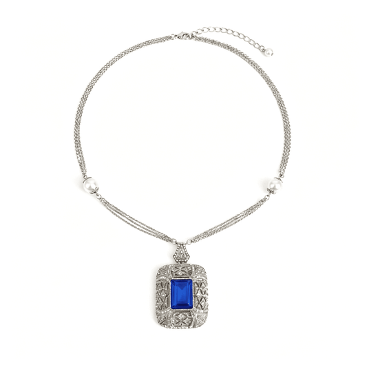 Ever P. baroque pearl necklace with a large blue sapphire pendant and gold knotted chain.