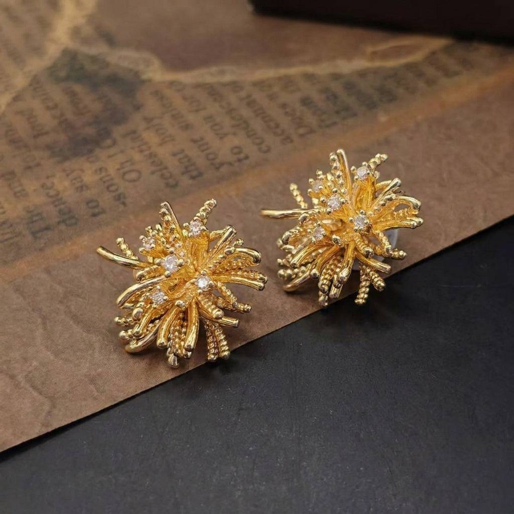 Close-up of the intricate gold starburst earrings encrusted with sparkling crystal rhinestones.
