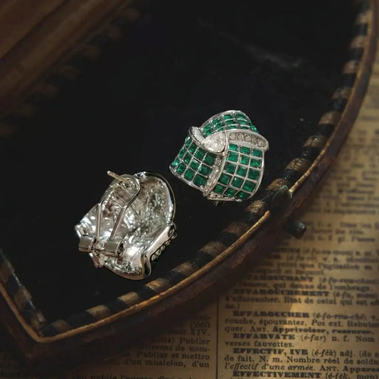 Detailed view of the deep green stone on 18K gold-plated vintage stud earrings.