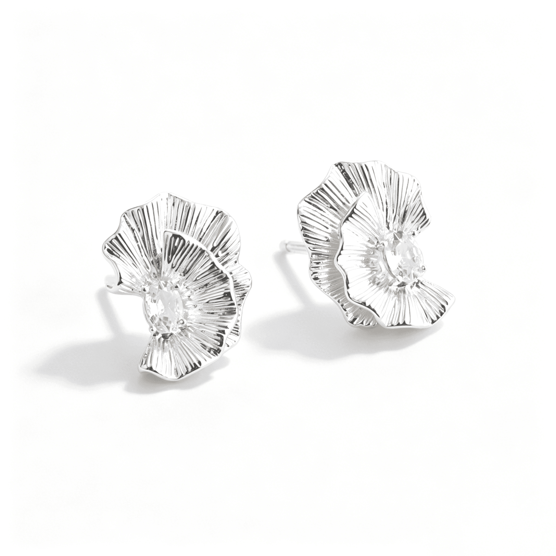Side view of Ever P. flower stud earrings, showcasing the unique 3D curved silhouette and metallic luster.