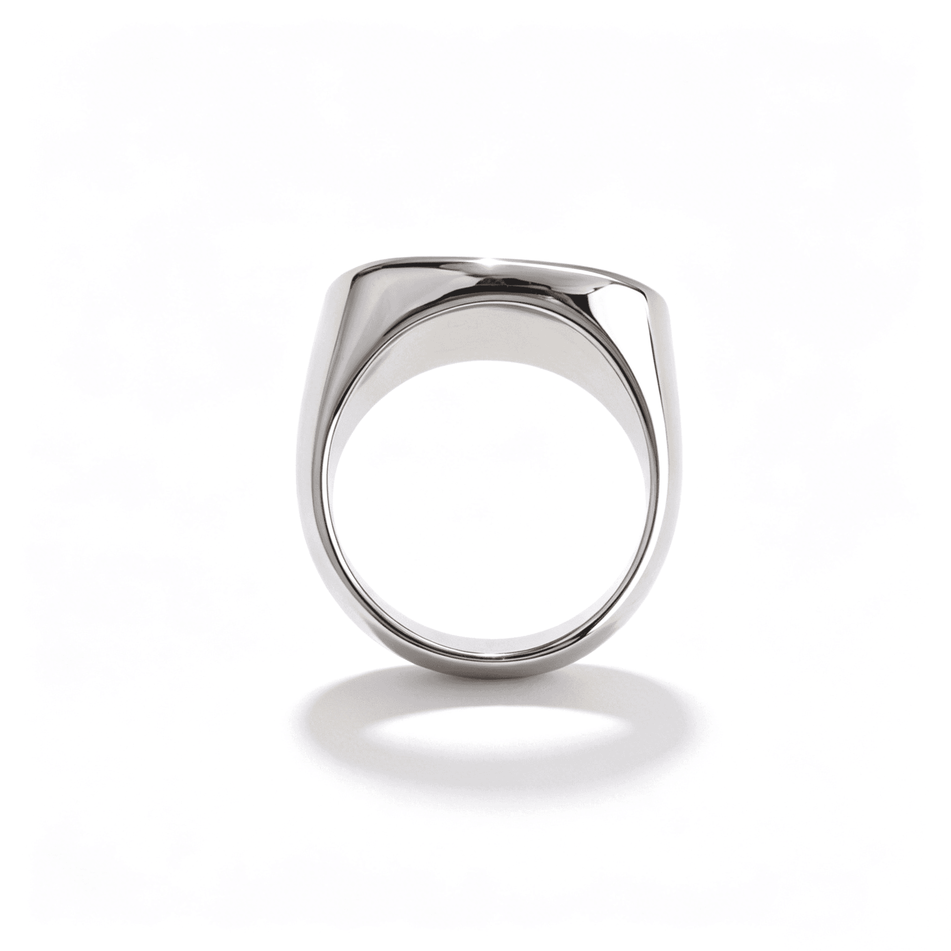 A pair of Ever P. stainless steel band rings in gold and silver, featuring oversized geometric signet designs.