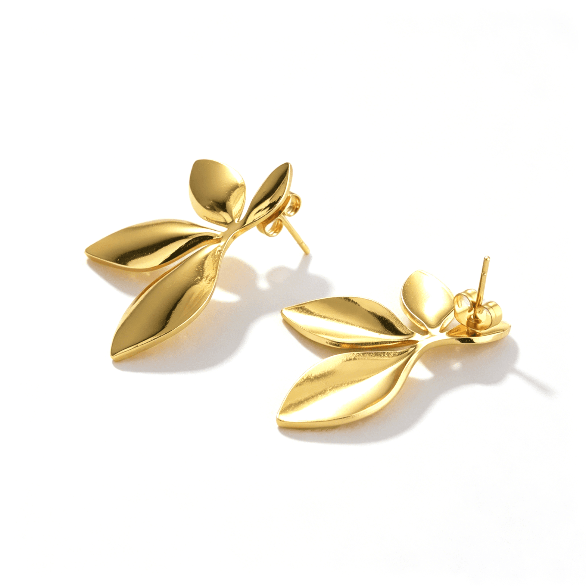 Ever P. gold leaf earrings, featuring an irregular geometric stud design with a rich 18K gold finish.