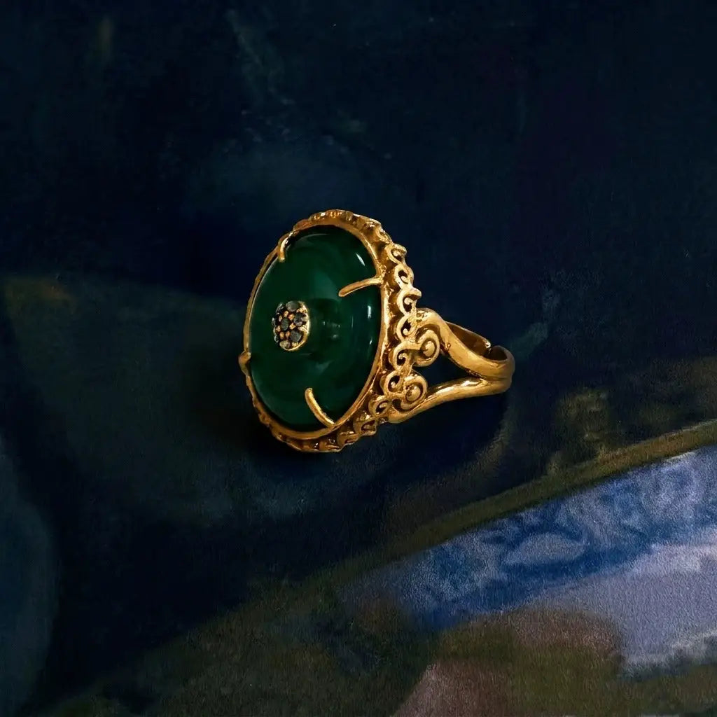 Side view of the Ever P. oriental style gold signet ring showcasing floral carvings.