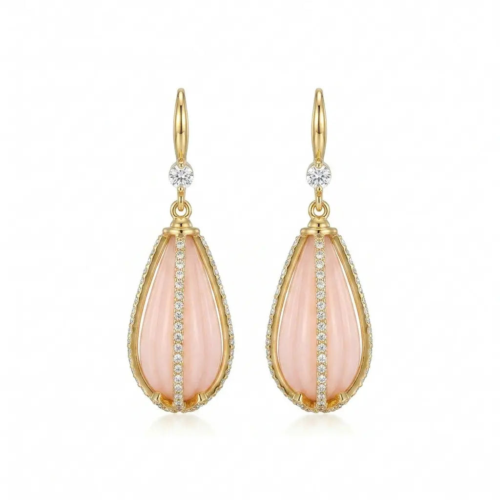 Ever P. gold teardrop earrings with a soft pink crystal stone and ornate filigree frame.