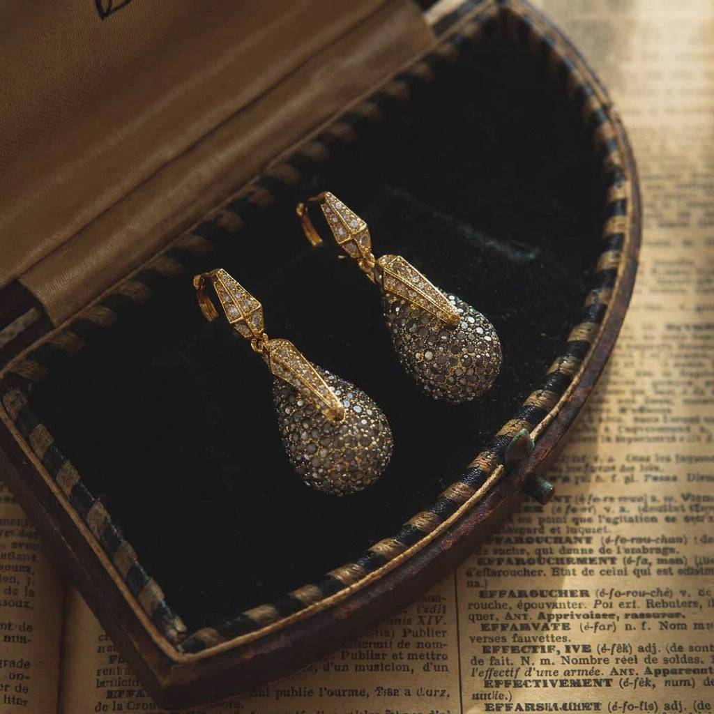 A detailed perspective of the 18K gold-plated teardrop earrings with a vintage feel.