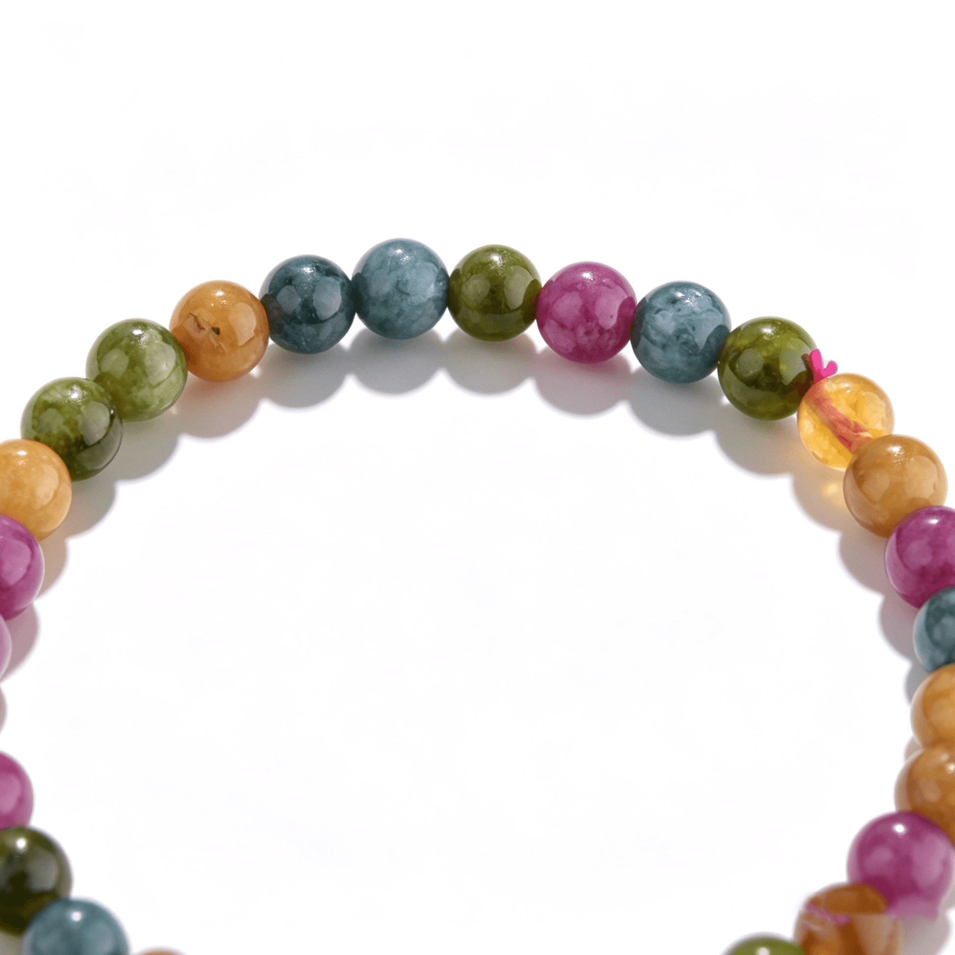Detailed artisan craftsmanship of an Ever P. handmade agate bracelet in vibrant hues.