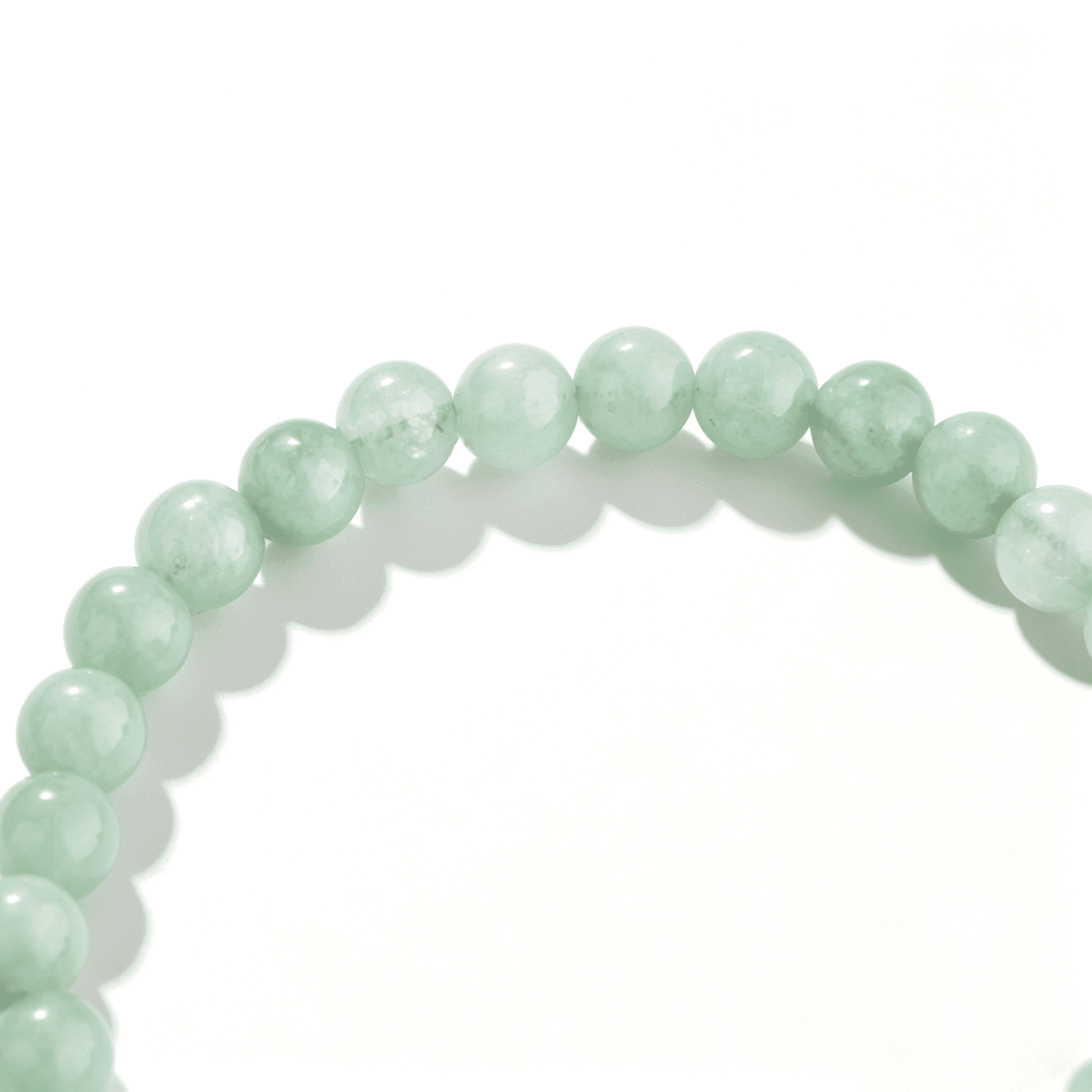 Detailed view of a handmade agate bracelet in a serene, translucent green.