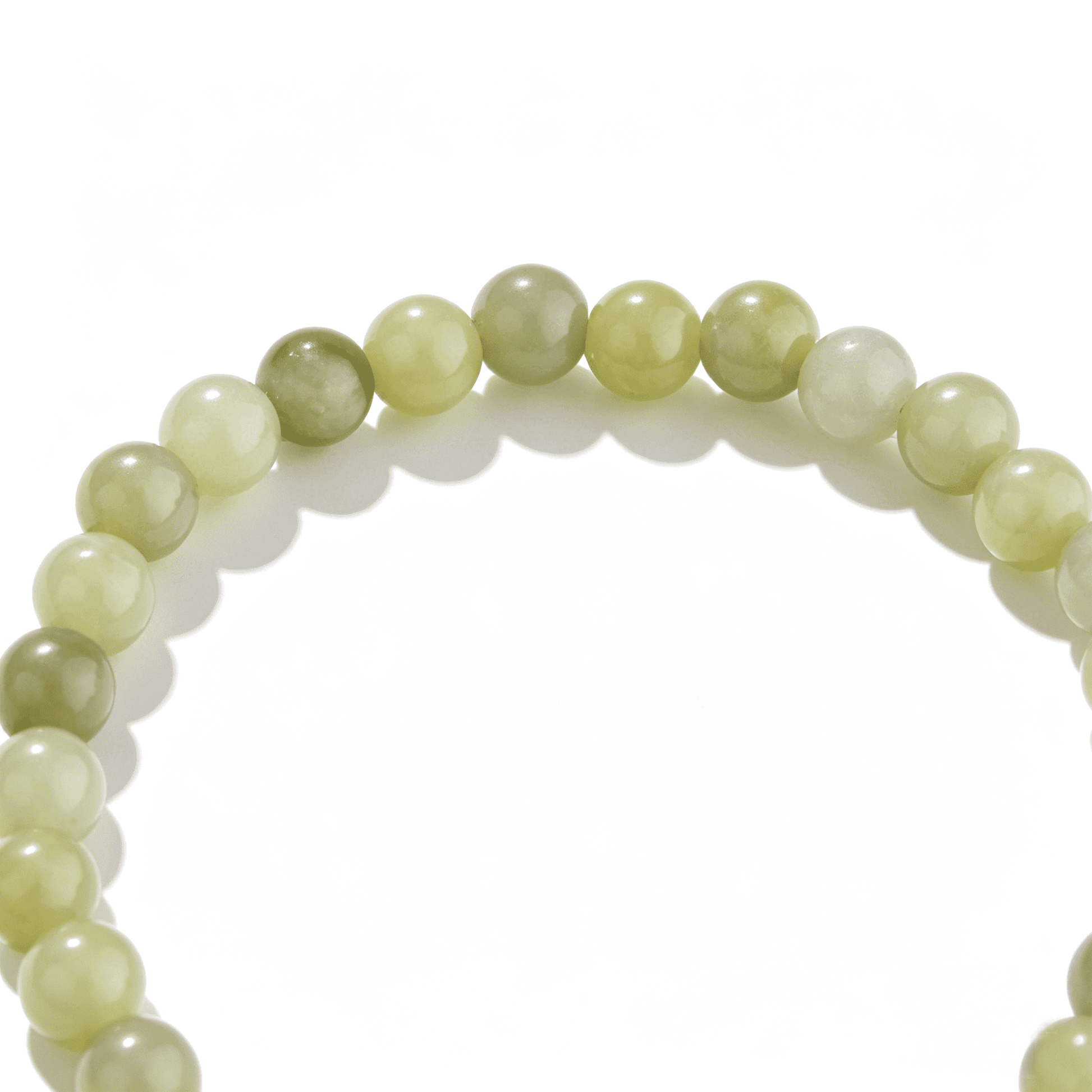 A detailed perspective of the handmade green agate crystal bracelet with a fresh lime tint.