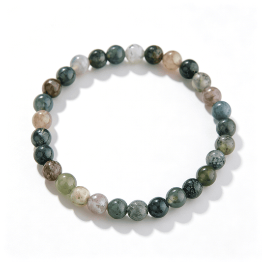 A full view of the handmade moss agate crystal bracelet in a natural color palette.