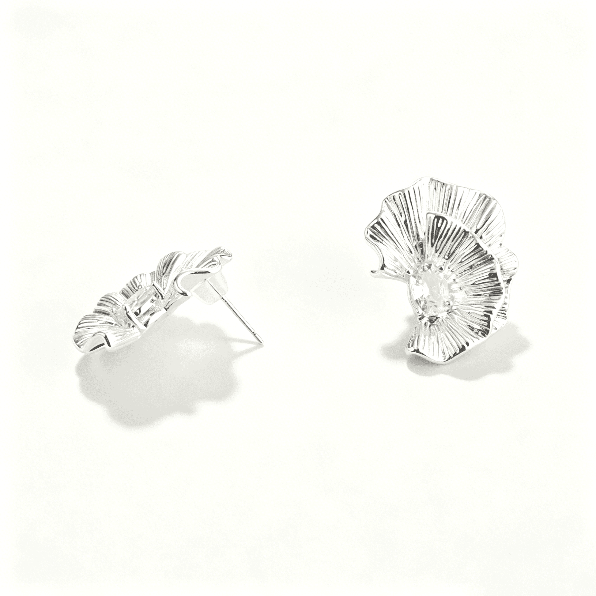 Close-up of the reflective mirror surface on the Ever P. silver flower stud earrings.