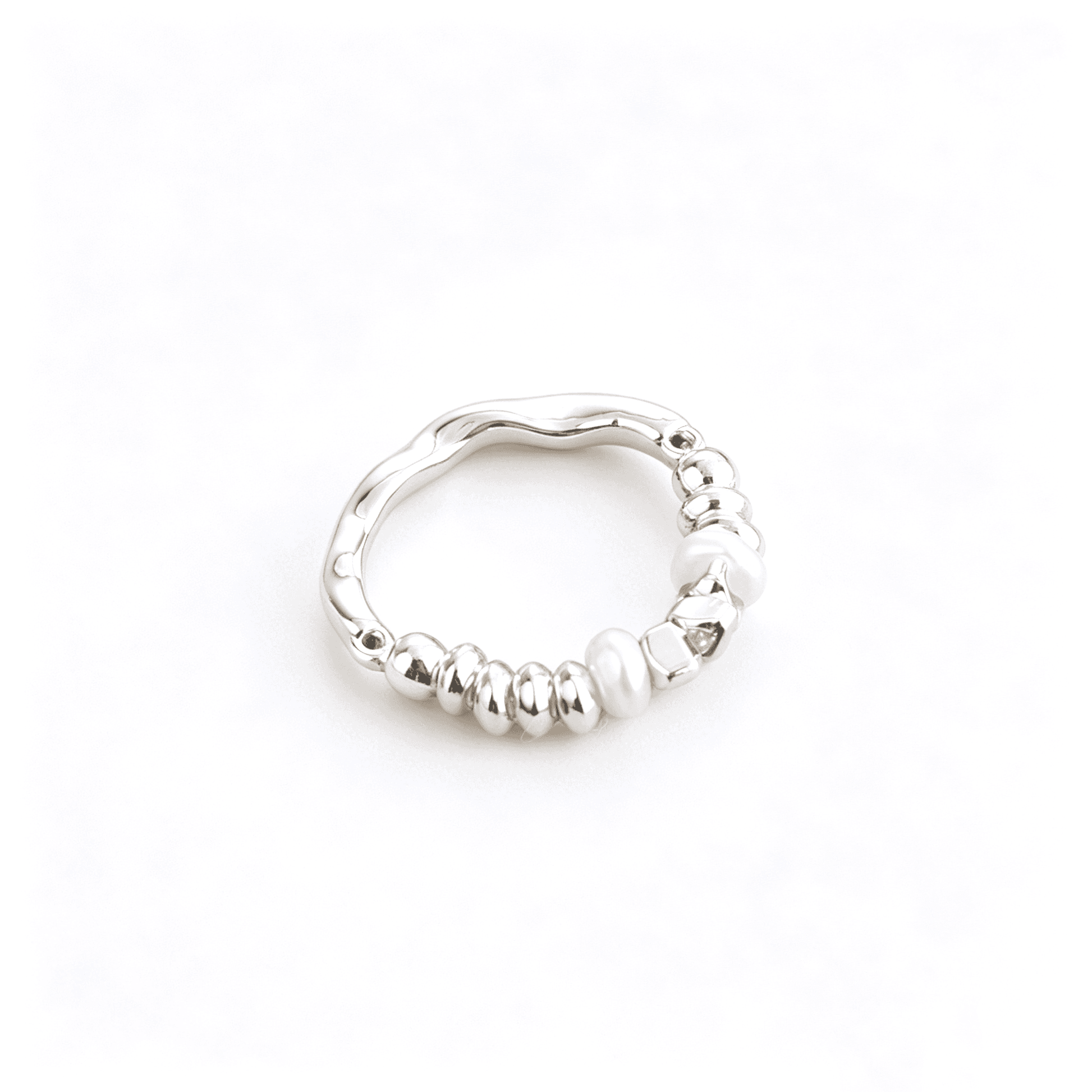 Front aesthetic view of Ever P. irregular baroque pearl ring with a molten textured chunky gold band.
