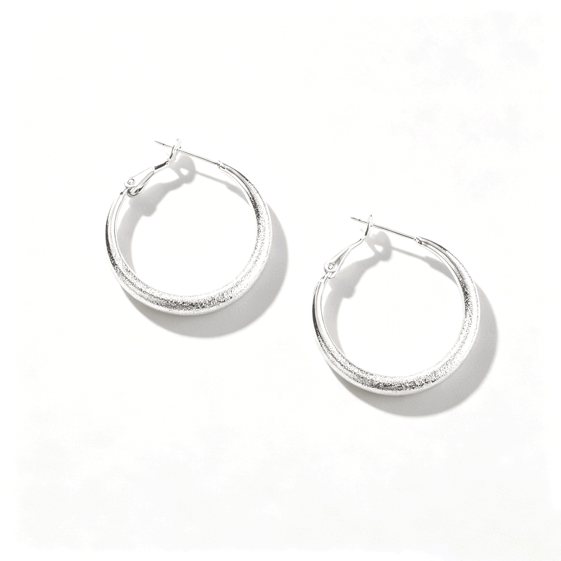 Ever P. minimalist silver jewelry collection featuring the large chunky tube hoop earrings.