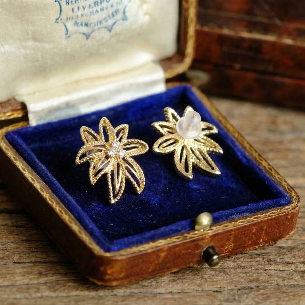 Side perspective of the 18K gold plated statement leaf earrings showcasing the open-work.