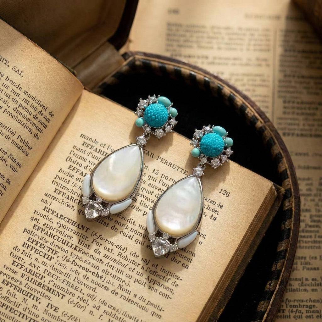 Side view showing the 4.6cm long drop earrings with iridescent mother of pearl.