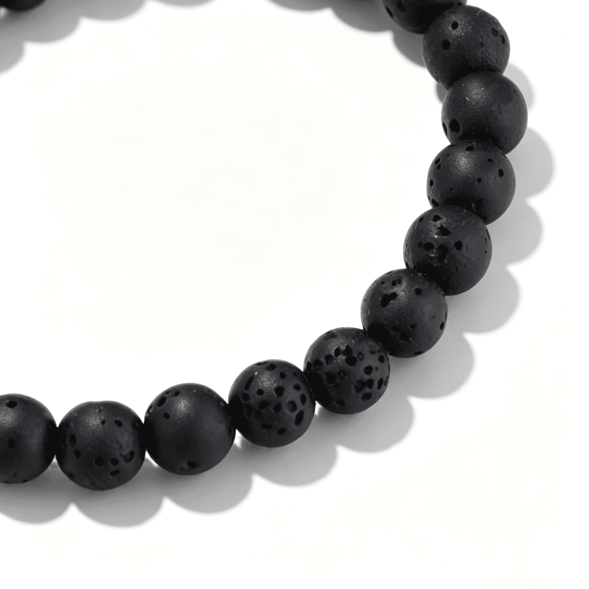 Close-up of the Ever P. Matte Black agate bracelet highlighting the porous stone-like texture.