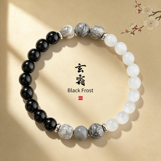 An exquisite scene shot of the Ever P. monochrome bracelet on a patterned background, featuring the "Black Frost" brand motif and Chinese characters