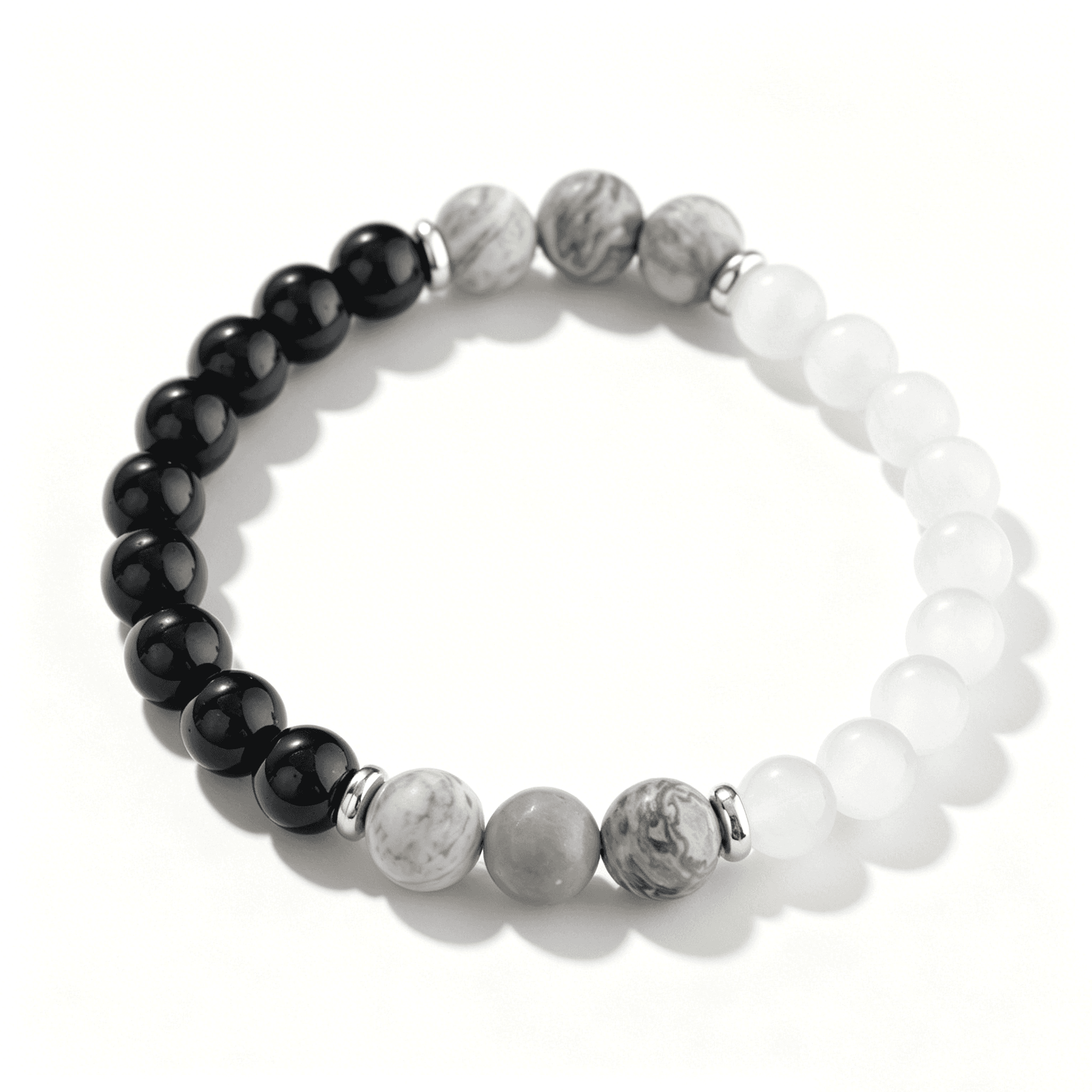 Overhead full view of an Ever P. monochrome beaded bracelet, showcasing the black, white, and detailed grey stone mix on a clean white background.