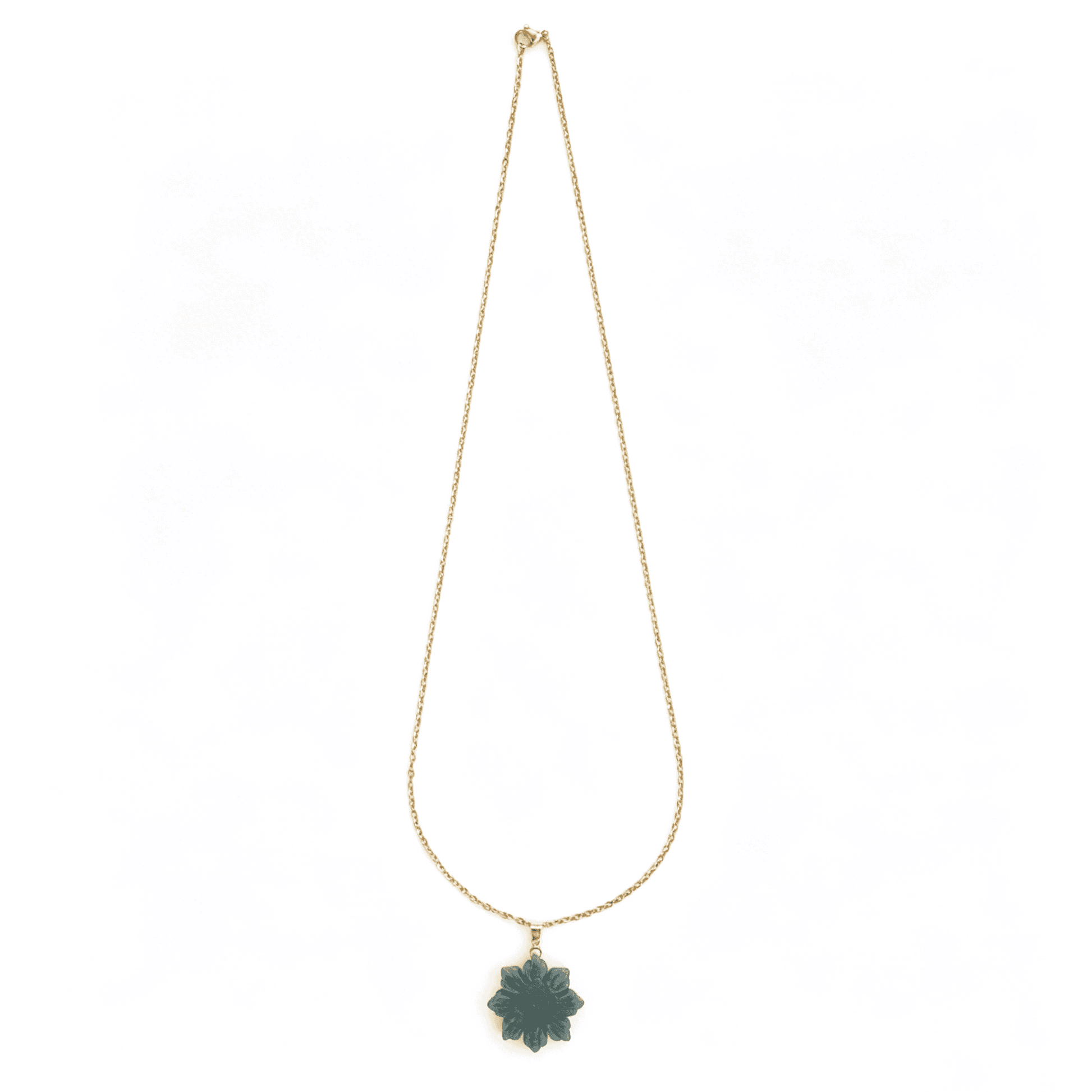 Hand-held view showcasing the opaque pastel green hues of the flower necklace under natural sunlight.