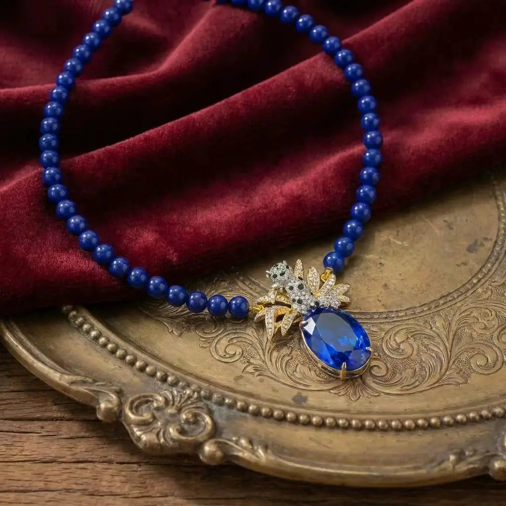 High-definition view of the ornate metalwork on the sapphire blue necklace set.