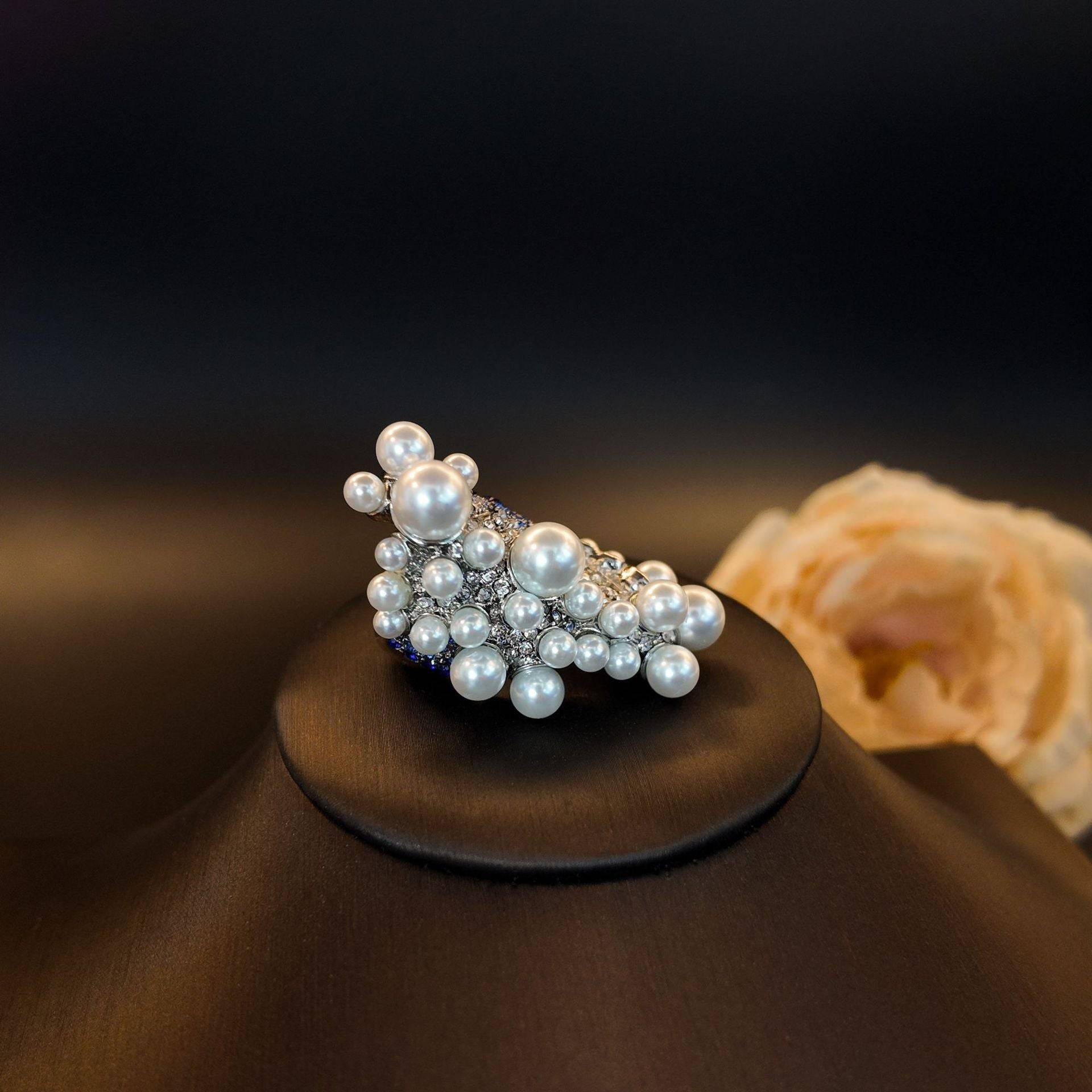 Front view of Ever P. ocean wave pearl ring, showcasing the irregular pearl cluster bubbles on a display stand.