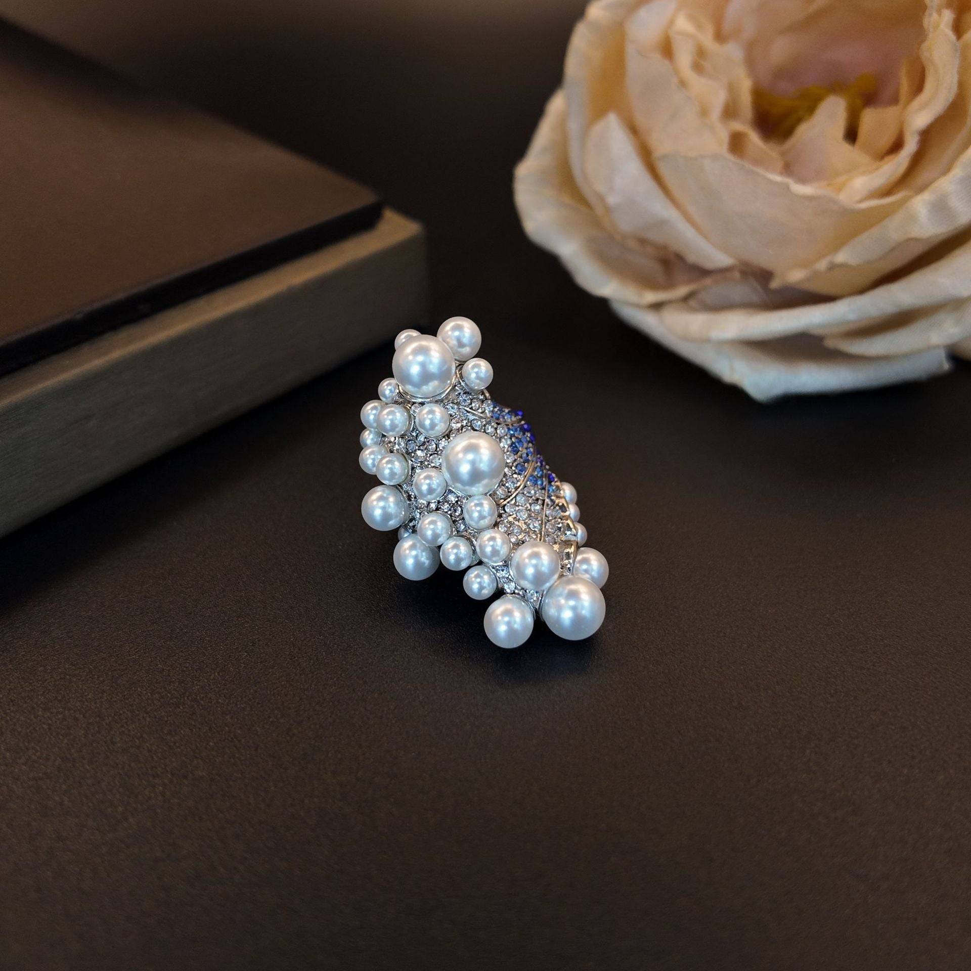 Side view showing the multi-layered height and exquisite craftsmanship of the faux pearl cluster wave ring.