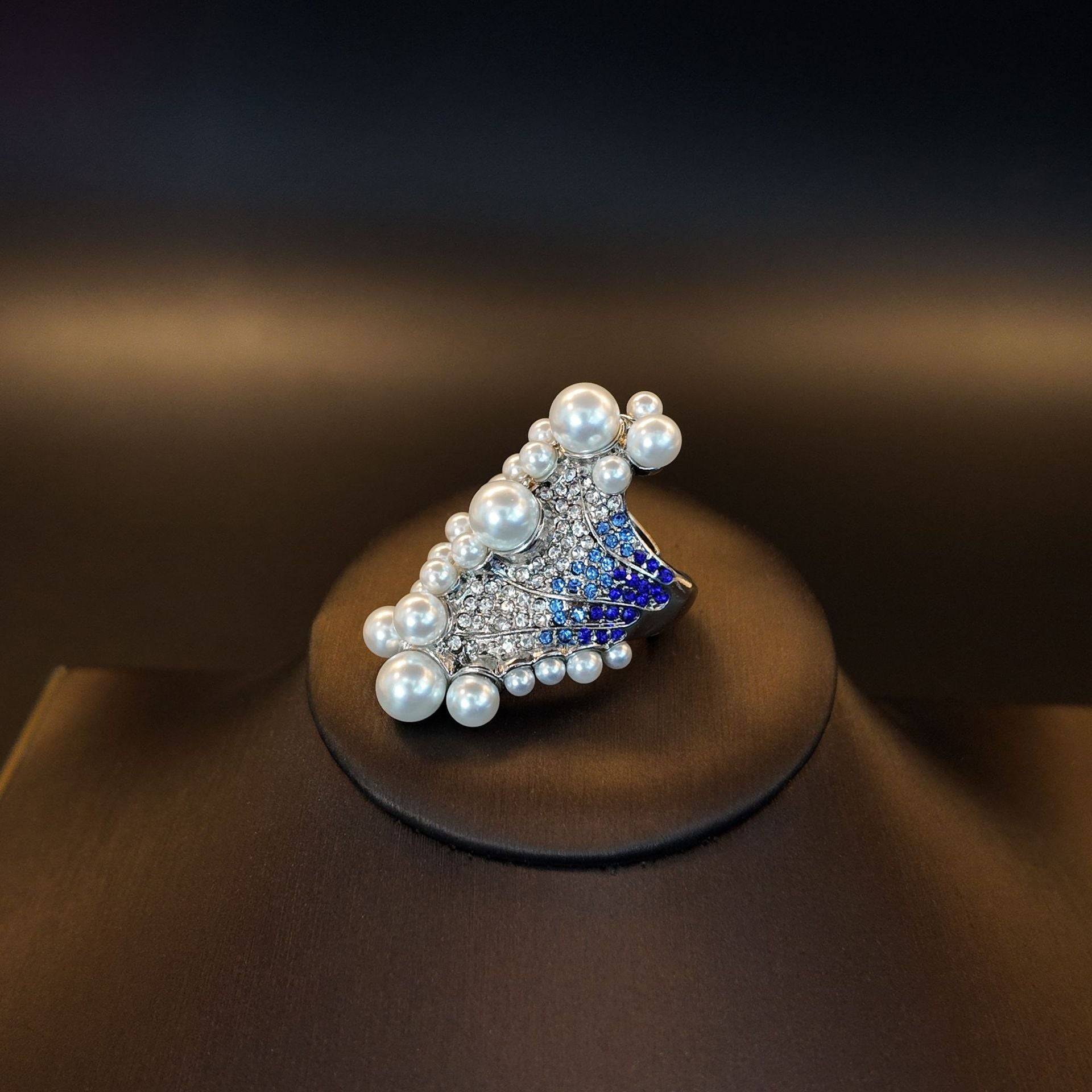 Studio product display of the mermaidcore luxury beach rings aesthetic with sparkling ocean color stones.