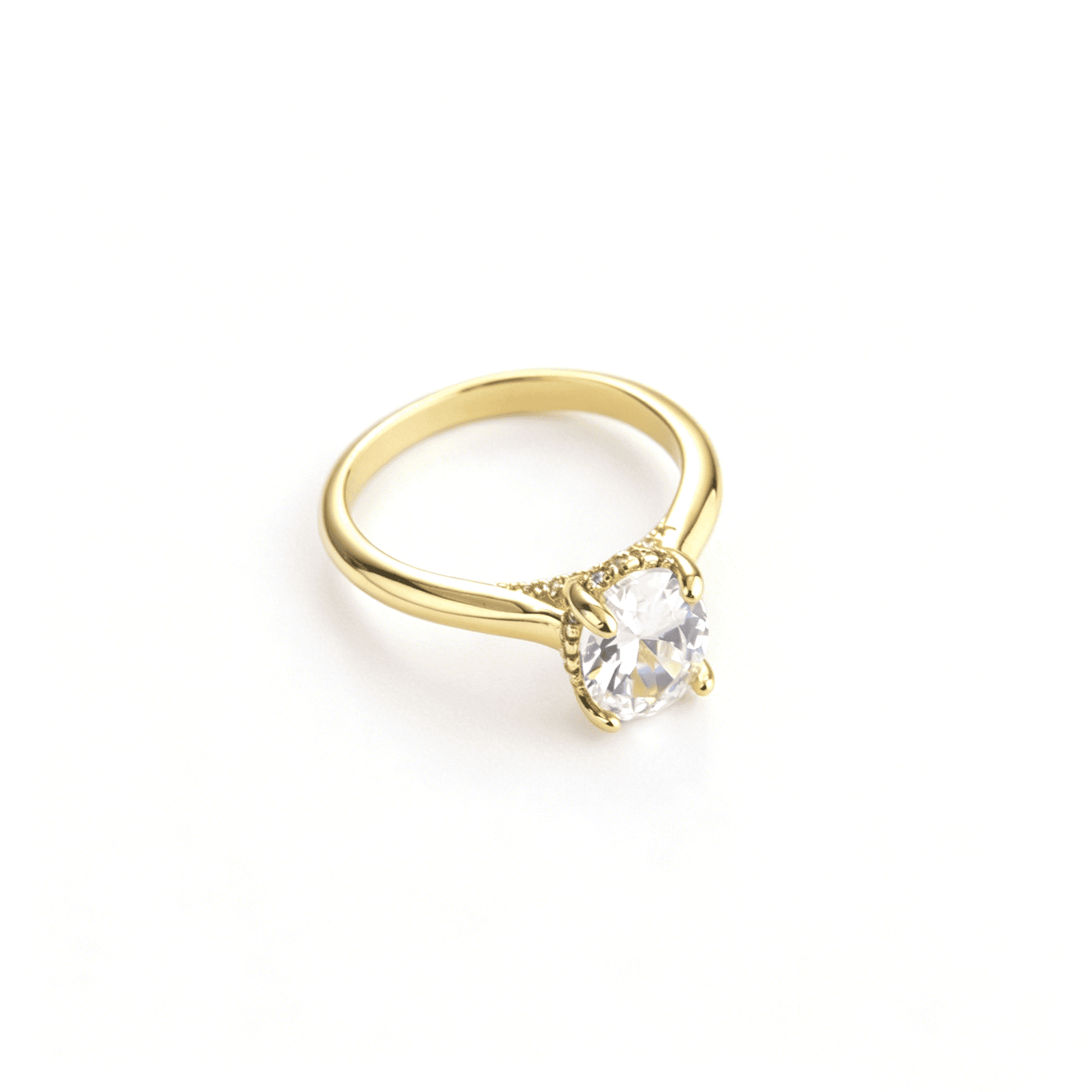 Side view showcasing the fine 4-prong diamond simulant setting on the slim gold rings profile.