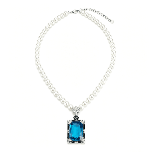Ever P. pearl necklace with a blue emerald-cut pendant on a gold snake chain.