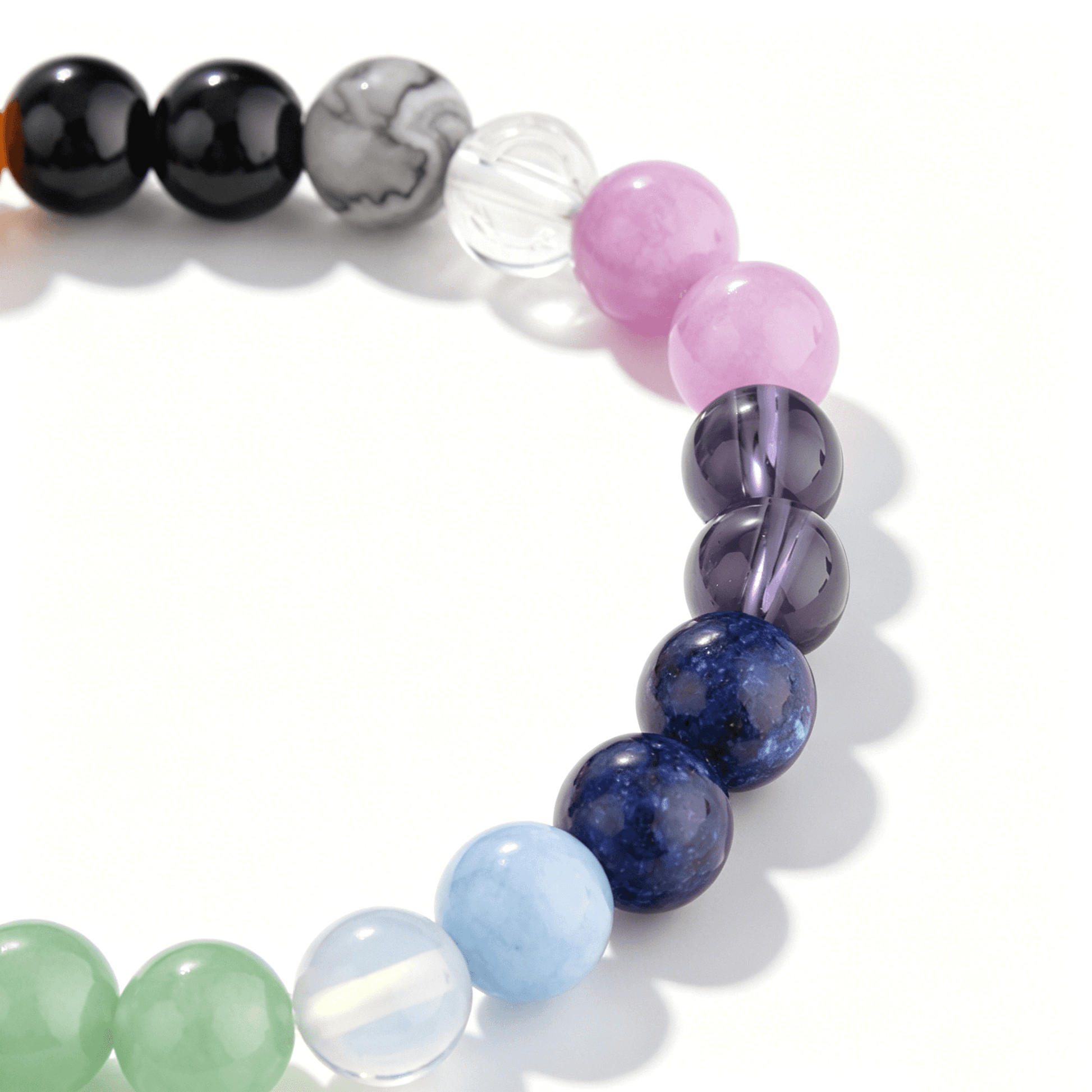 A collection of Ever P. gemstone bracelets featuring the vibrant multi-color spectrum of natural rainbow strawberry quartz.
