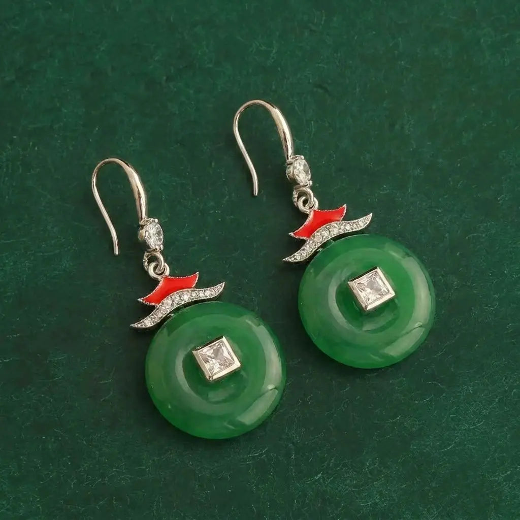Side view showing the 4.8cm length of the red drop earrings with an oriental amulet motif.