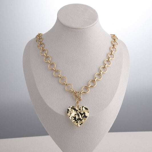 Style reference: the Ever P. sculptural gold heart pendant necklace on a model, showcasing its bold collarbone presence.