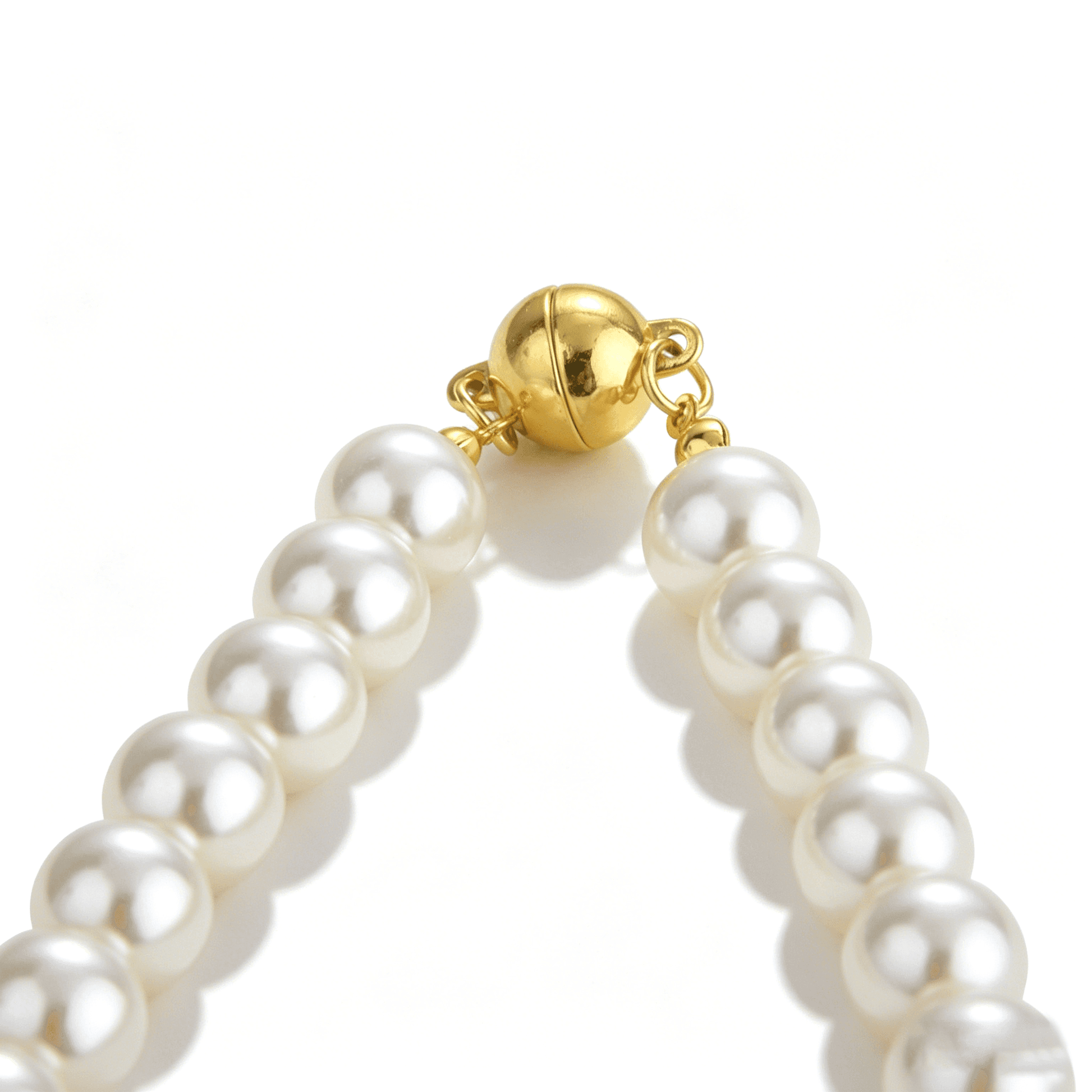 The secure and stylish toggle clasp of the Ever P. single strand pearl necklace with a butterfly charm.