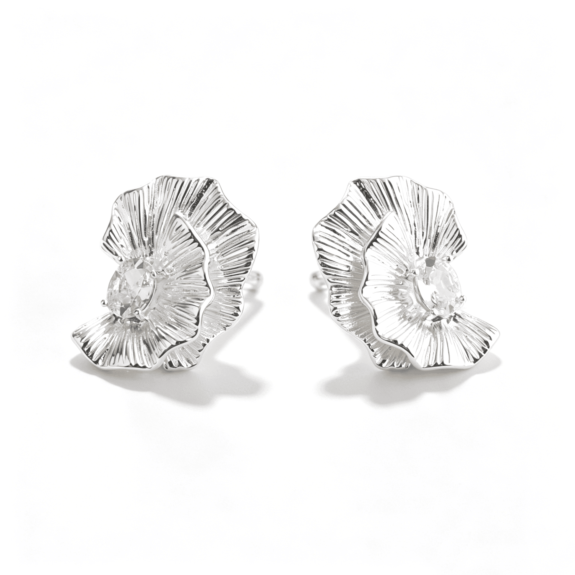 Top view of Ever P. statement stud earrings in a floral shape, highlighting the hollow and lightweight design