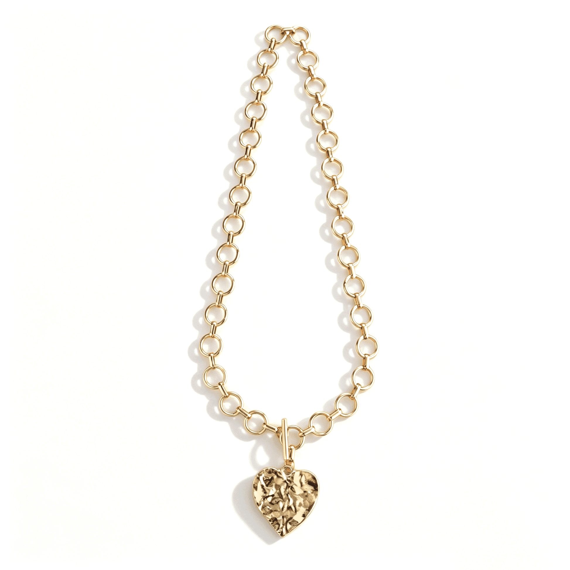 Ever P. textured gold heart pendant necklace, featuring a distinctive raw, hammered surface design.