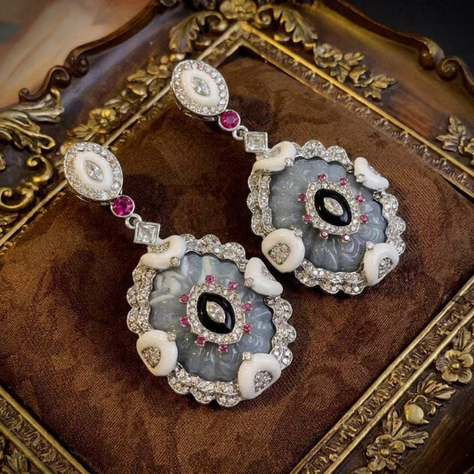 Detailed view of the 18K gold-plated relief carving on Ever P. vintage drop earrings.