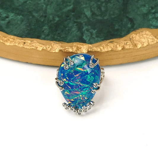 Front view of Ever P. vintage gold opal ring, showcasing the bold 2.2x2.6cm geometric blue fire stone.