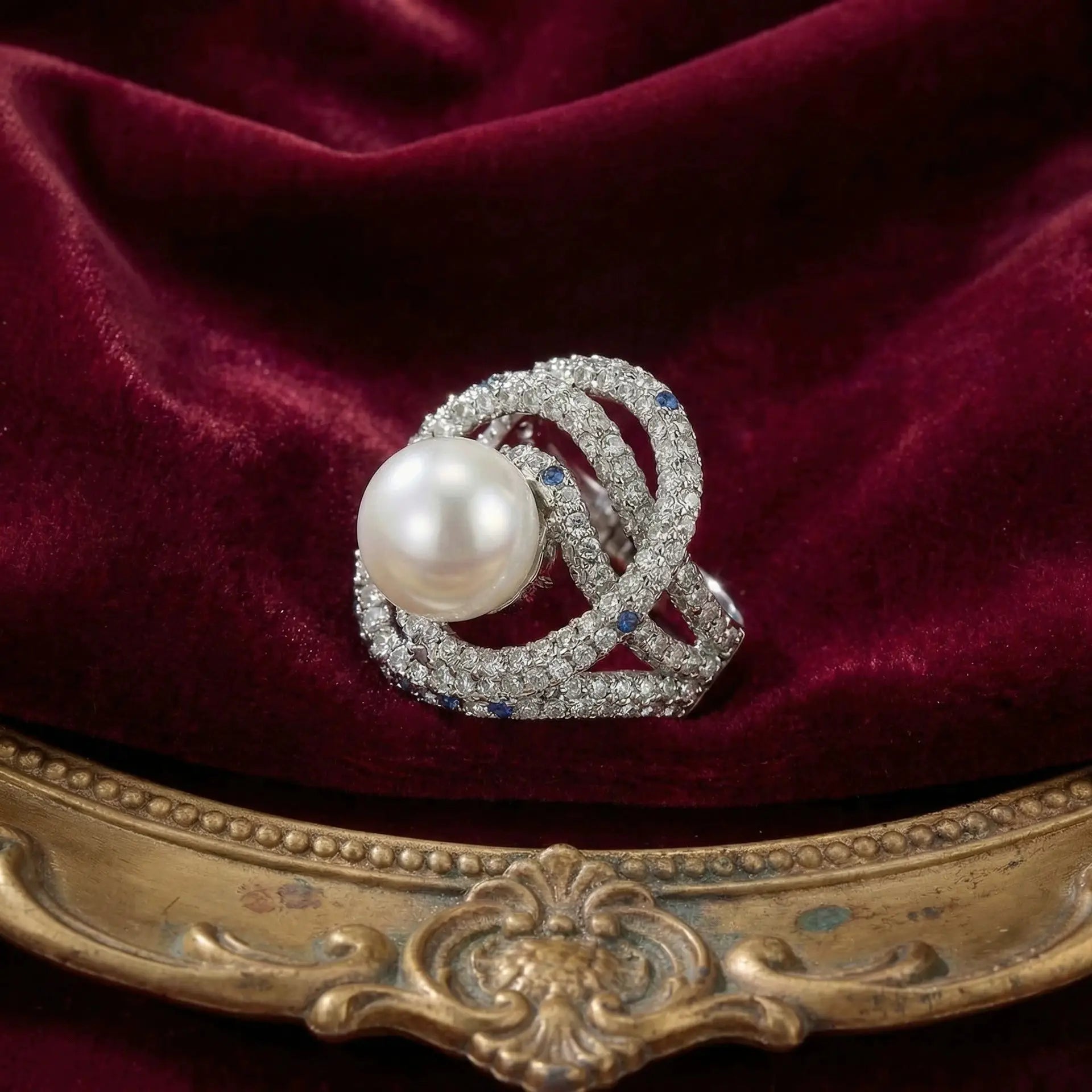 Ever P. vintage pearl cocktail ring with layered gold bands and crystal accents.