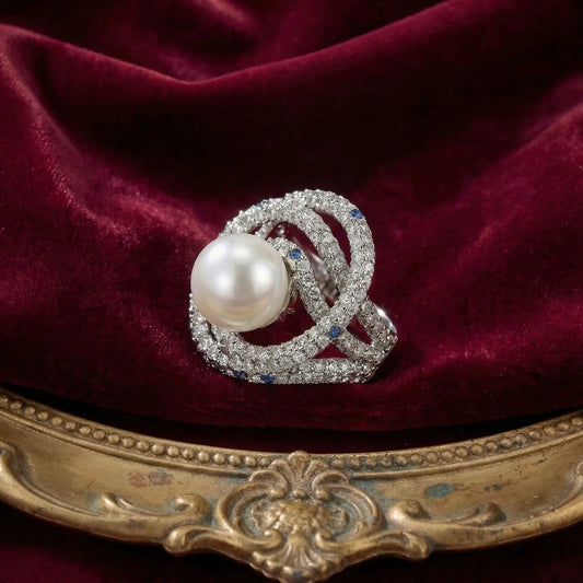 Ever P. vintage pearl cocktail ring with layered gold bands and crystal accents.