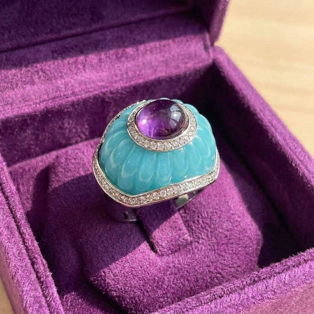 Detailed finger-wearing shot of the burnt orange ribbed cocktail ring styled with high-end luxury resort wear outfits.