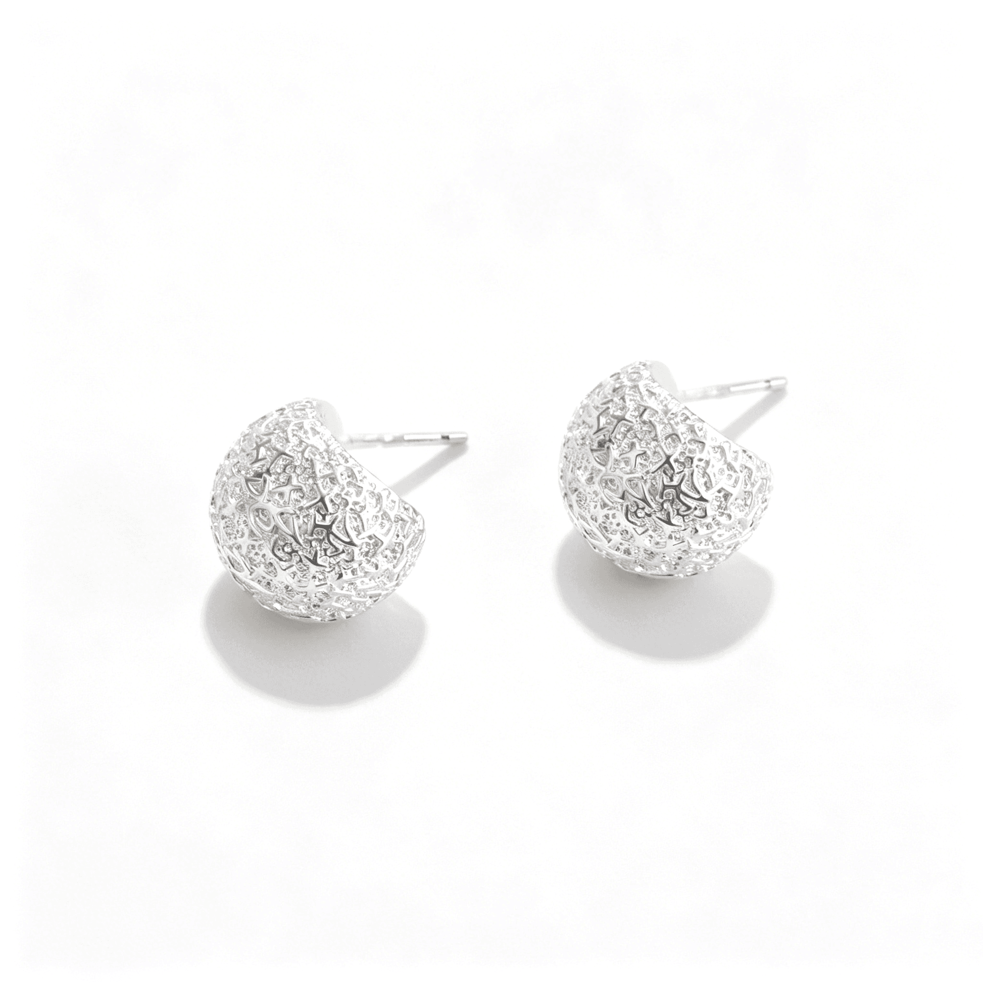Close-up of Ever P. vintage style hammered silver earrings, focusing on the sophisticated molten-metal texture.