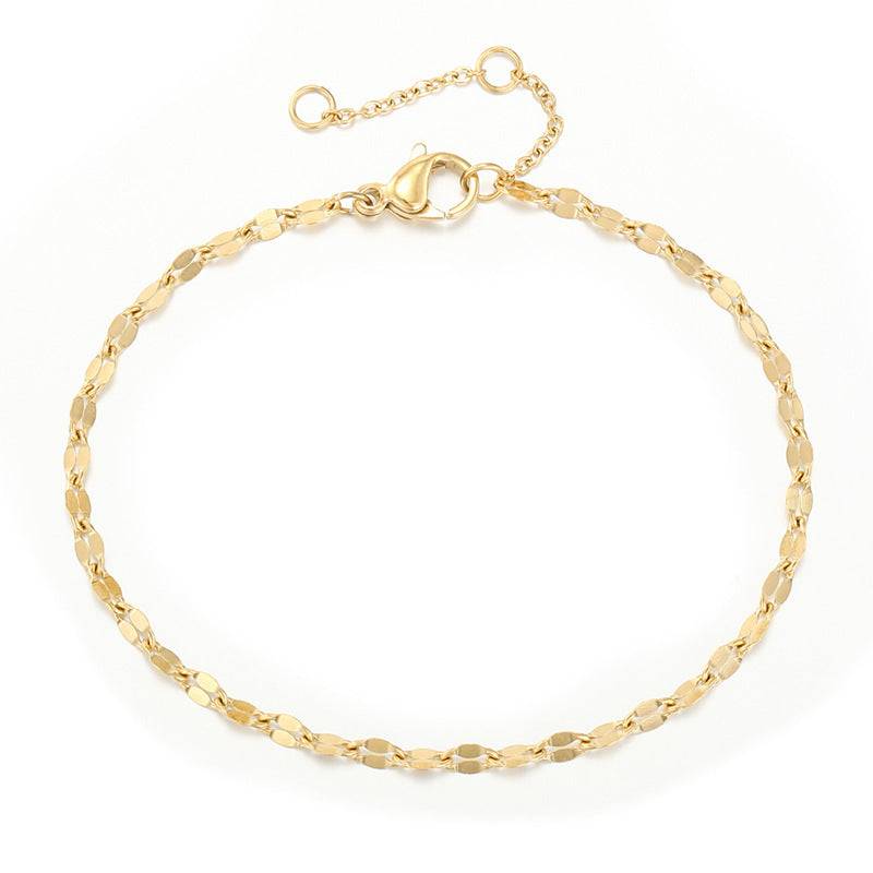 Gold flat link bracelet with lobster clasp and three-centimeter extender on white
