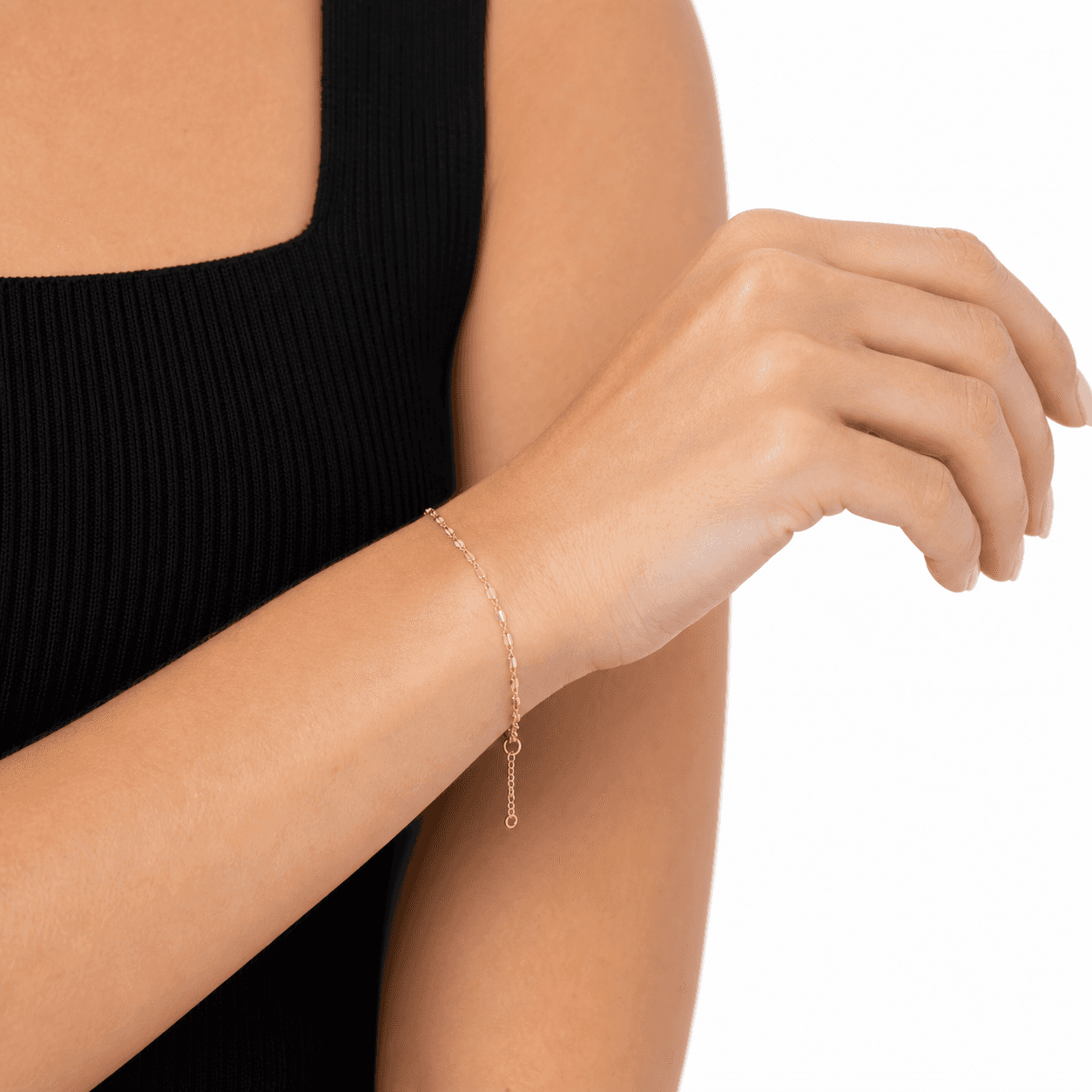 Close-up of an 18K gold-plated flat link bracelet wrapped around the wrist