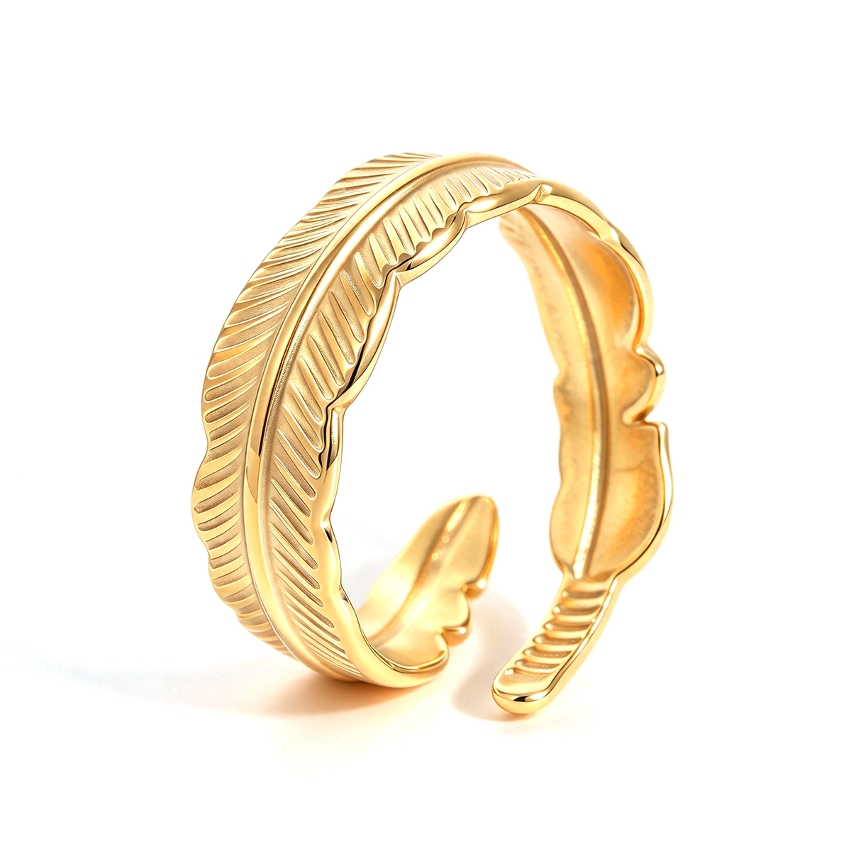 Gold-tone open ring showing layered feather-shaped curves and fine engraved lines.