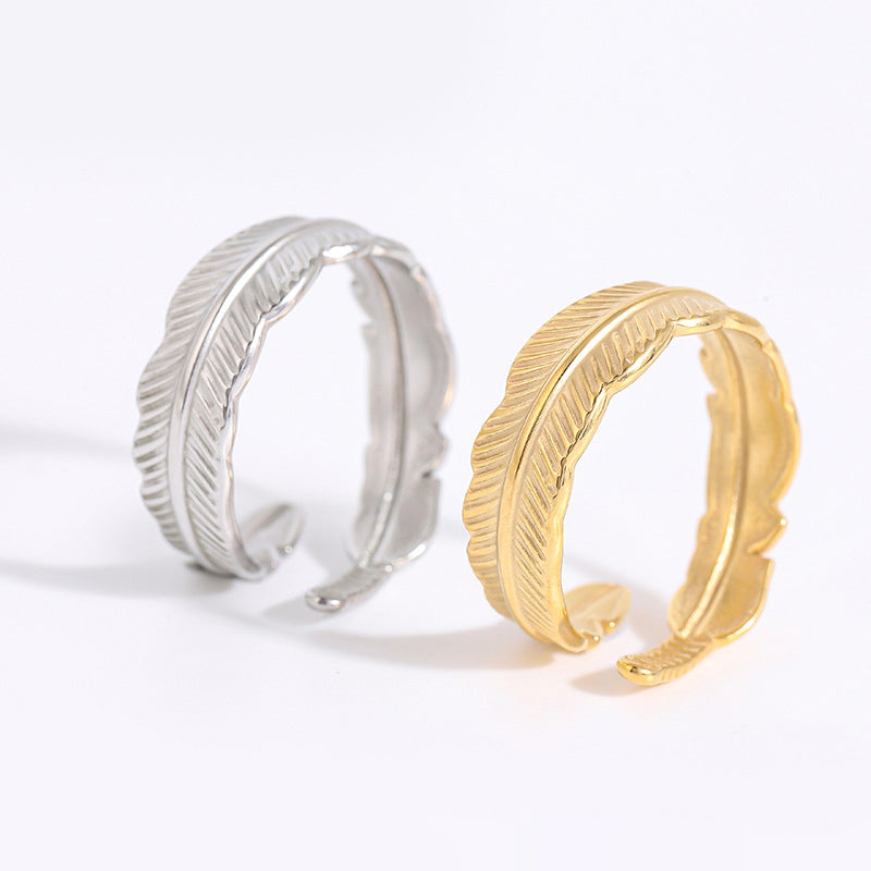 Silver-tone and gold-tone feather leaf rings displayed side by side to show both color options.